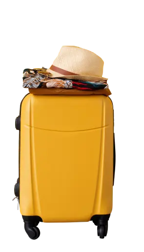A yellow suitcase with black wheels stands upright; folded clothes and a straw hat are neatly stacked on top, ready for travel.
